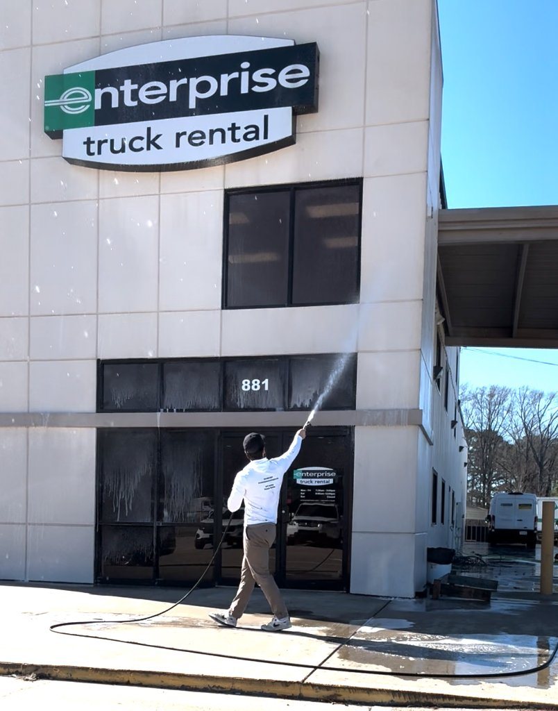 Washing an Enterprise Truck Rental storefront